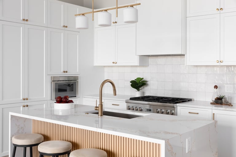 Kitchen detail with white cabinets and marble countertop
