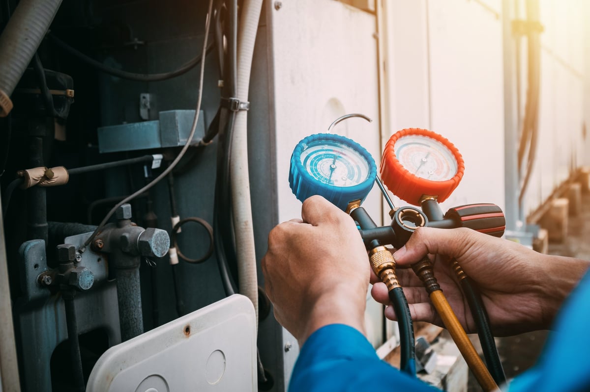 Technician is checking air conditioner refrigerant leak