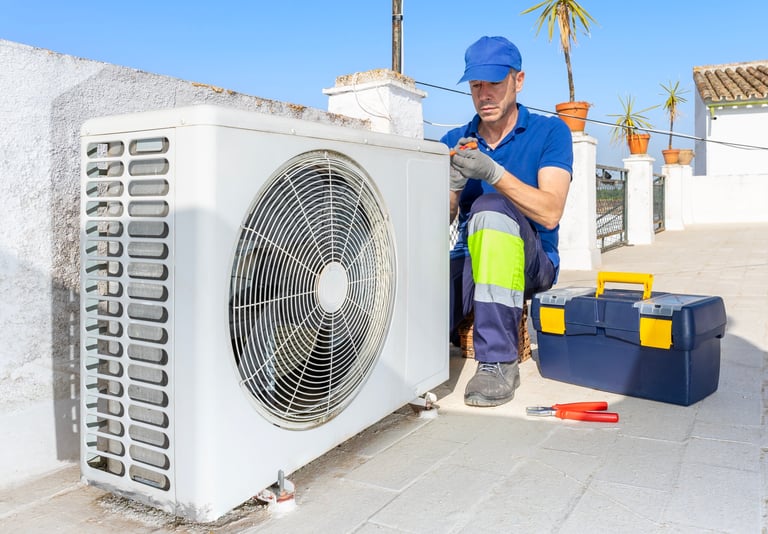 HVAC technician performing air conditioner maintenance