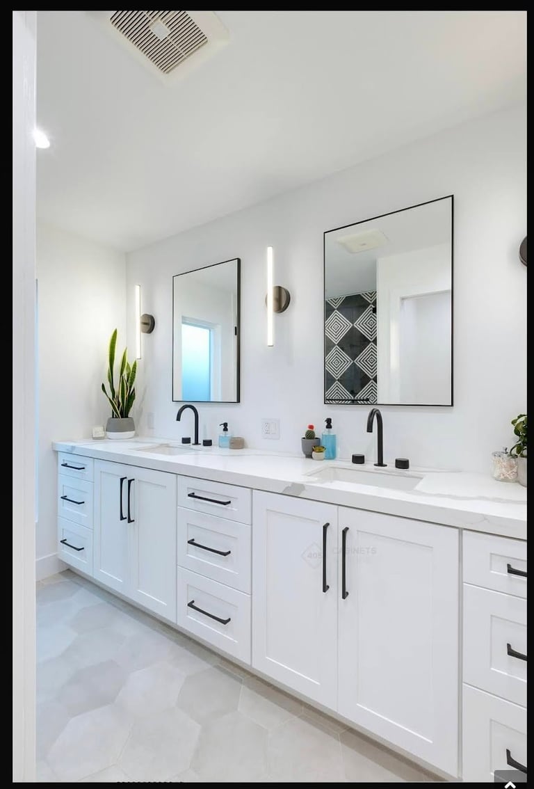 Modern white bathroom with double vanity, dual mirrors with black fixtures, and minimalist decor