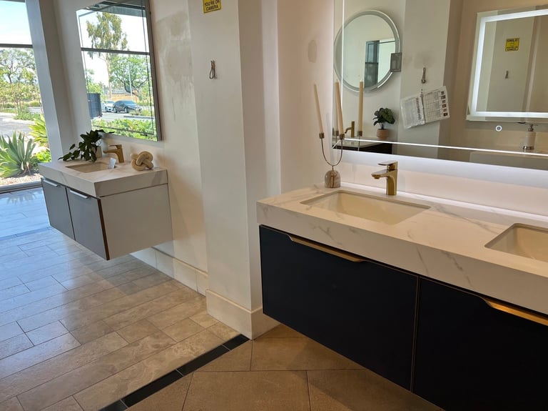 Modern bathroom with double vanity sink, round mirror, black cabinetry