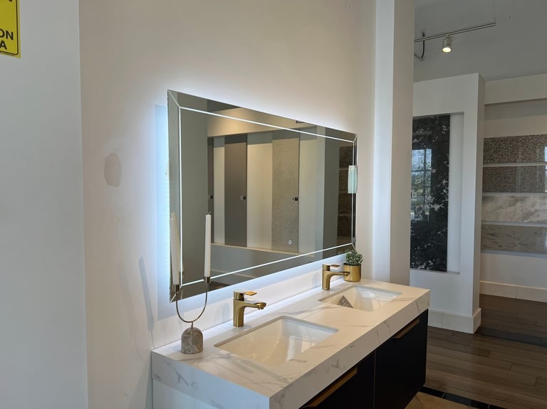 Modern bathroom vanity with white marble countertop, dual white sink bowls, brass faucet