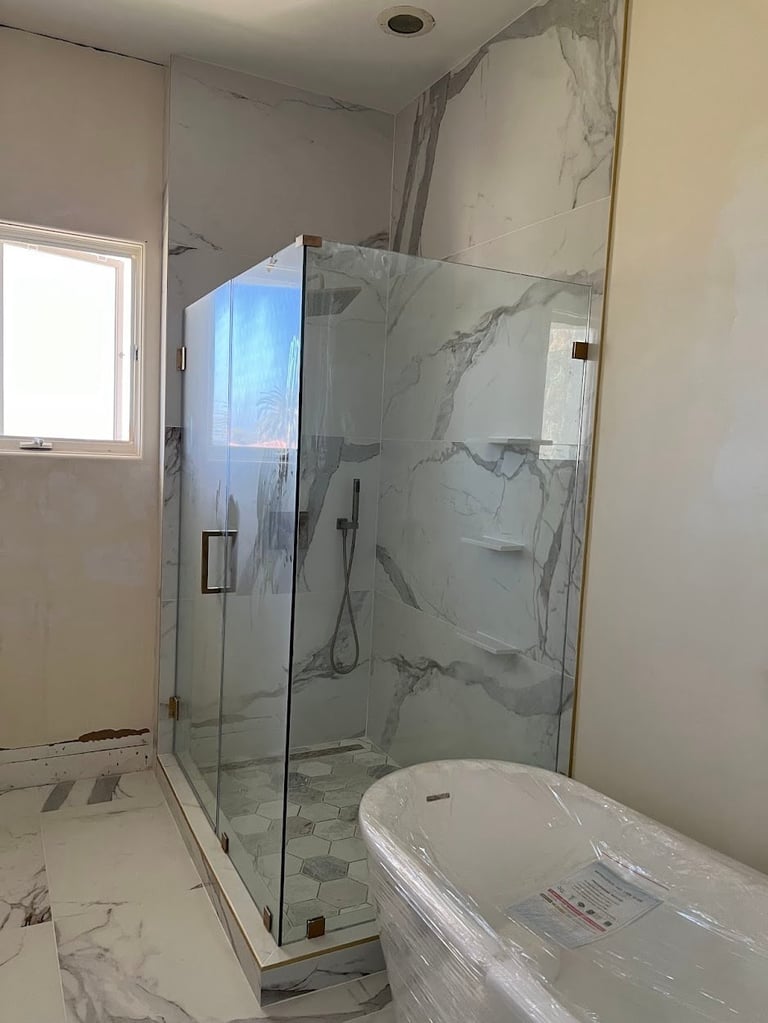 Modern bathroom with marble shower enclosure and window with natural light