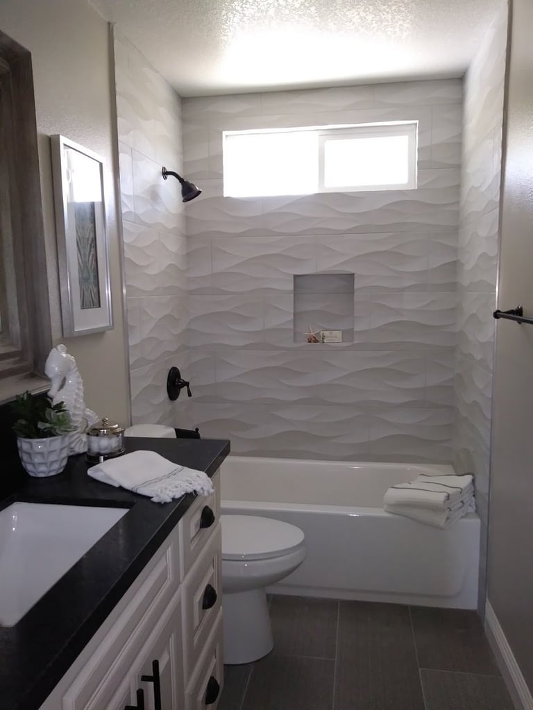 Modern bathroom with wavy tile walk-in shower and frosted window